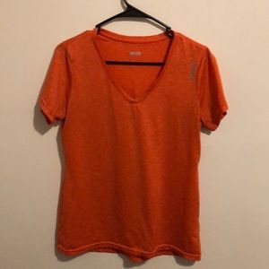 Reebok orange and white tee with v neck.